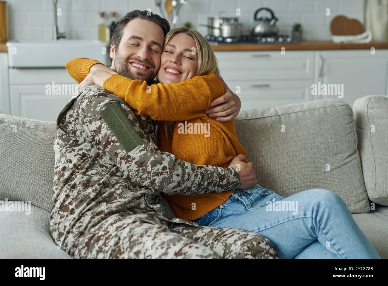 Happy young man in military form hugging his wife after coming home ...