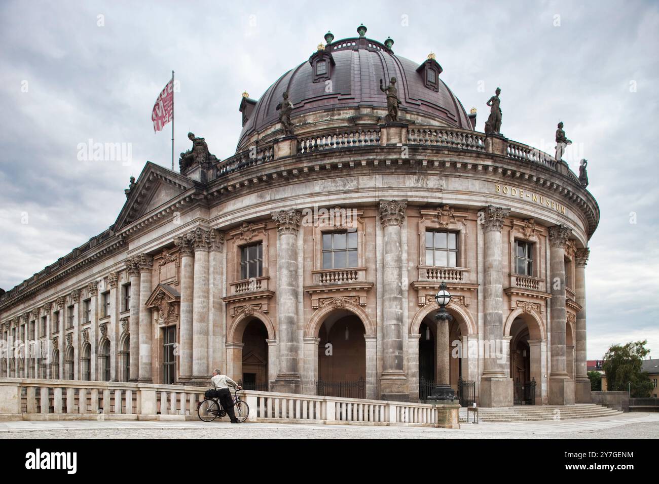 The impressive Bode Museum stands majestically on Museum Island in Berlin, highlighting its architectural beauty against the cloudy sky. Stock Photo