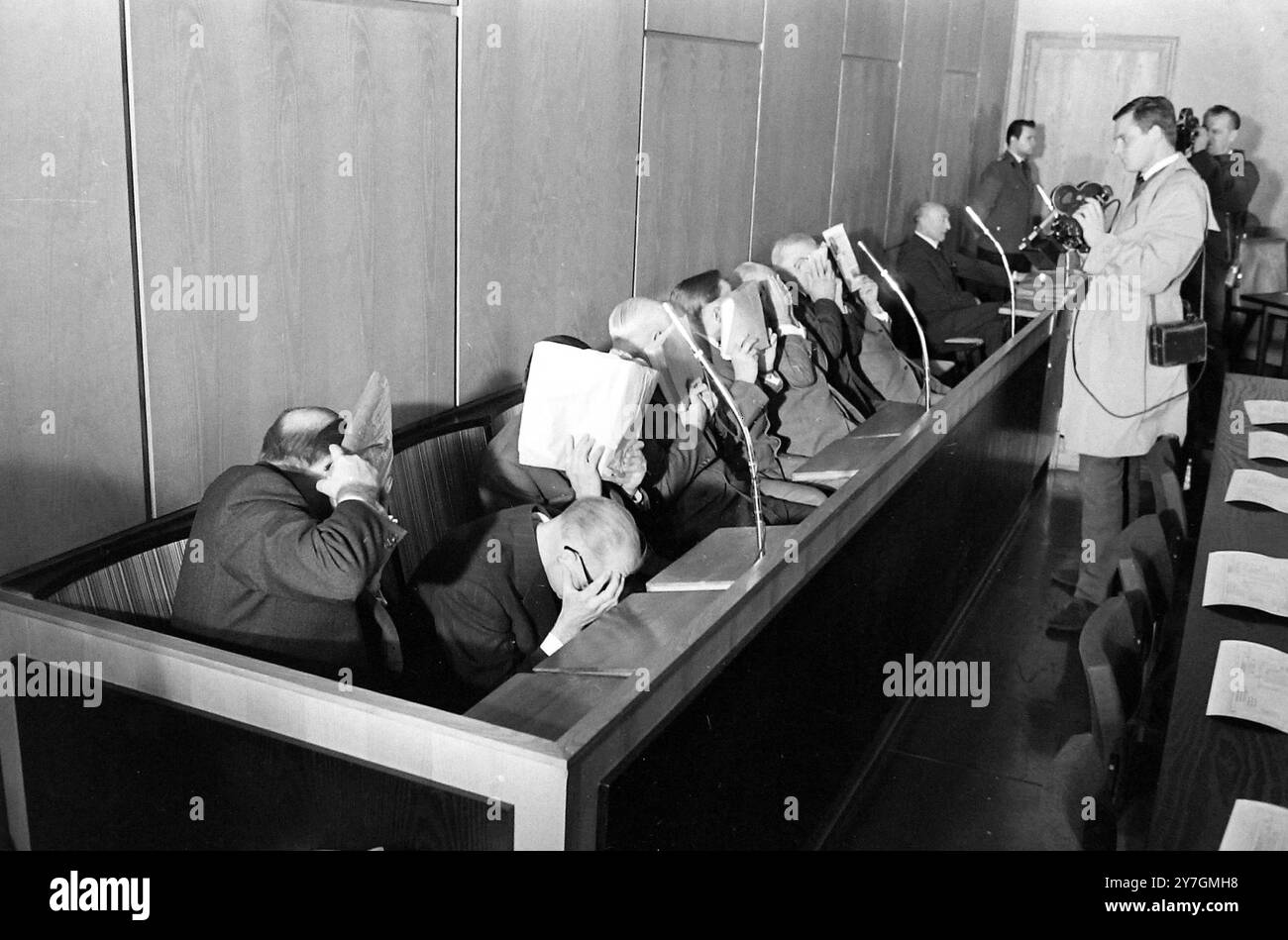 Opening of the Treblinka concentration camp trial. Seven of the ten defendants in the trial hide their faces from the photographers as they await opening of their trial on October 12th.They are left to right: Karl Hubert Franz, Otto Stadie, Heinrich Mathes, Willy Nentz, August Niete, Franz Suchonel and Gustav Munzberger, Identity is not guaranteed. 12 OCTOBER 1964 Stock Photo