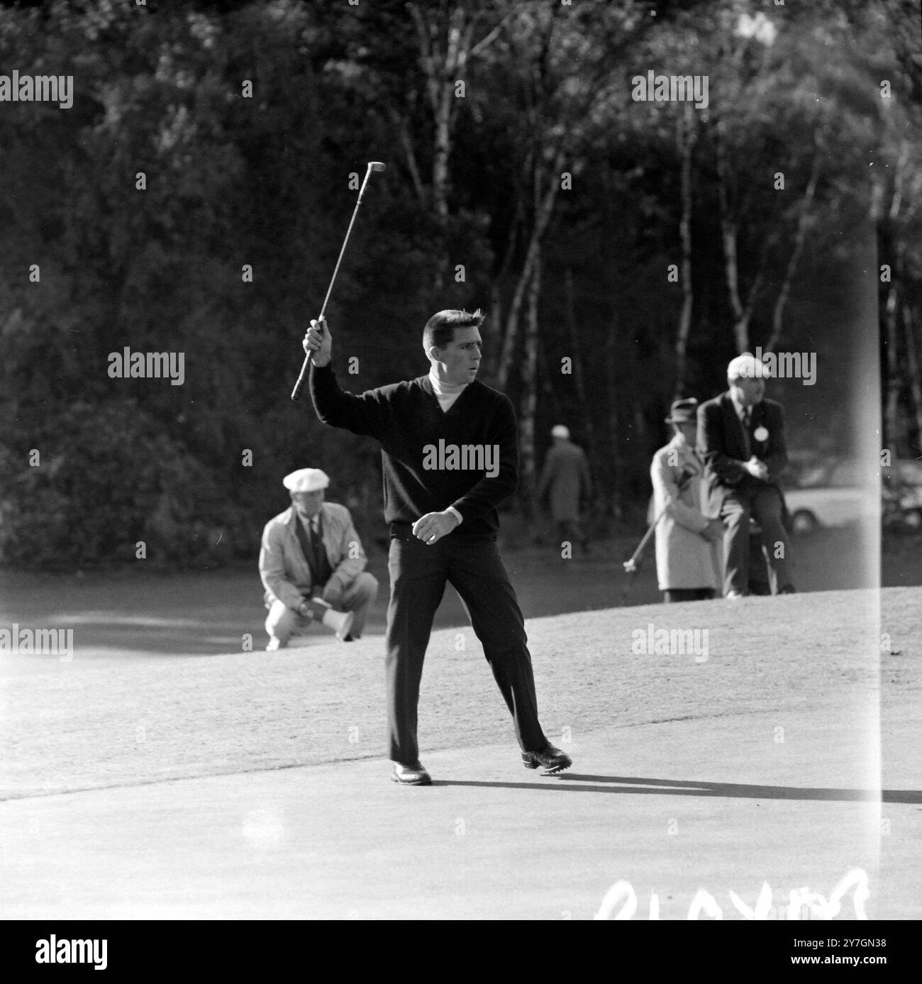 Virginia Water , Surrey :  Gary Player of South Africa seems to be coaxing his ball into the hole as he missed a putt on the 6th green during his semi-final match against American Arnold Palmer  in the £16,000 Piccadilly World Match-Play Golf Tournament over the west course of the Wentworth Club . 10 October 1964 Stock Photo