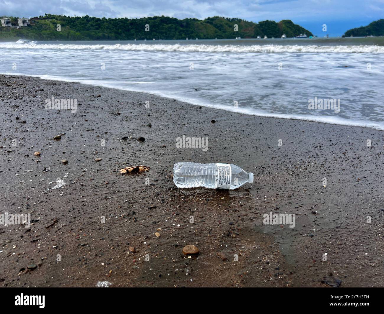 Plastic water bottle discarded along the beach Stock Photo