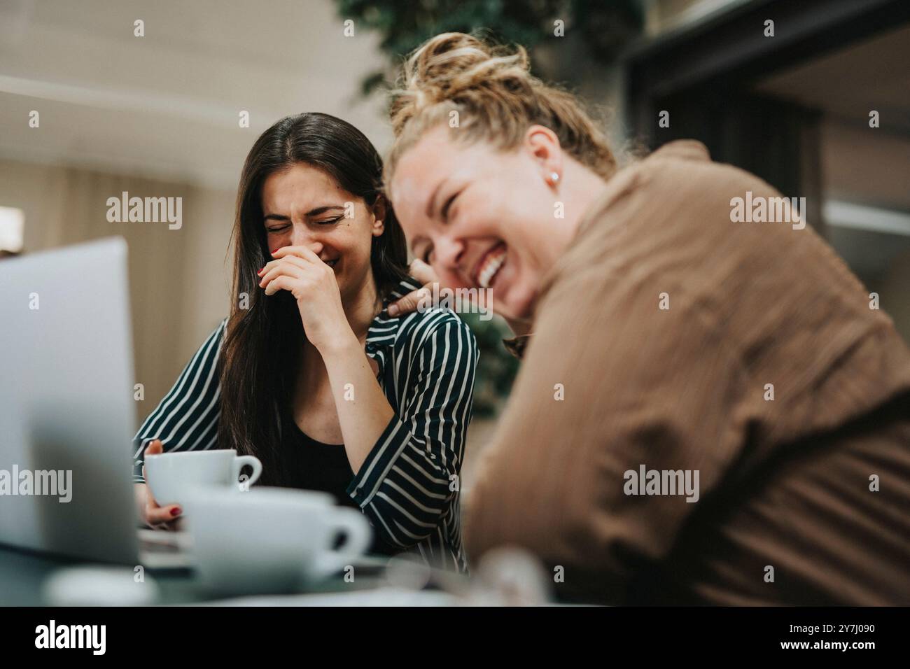 Female colleagues having fun at coffee break in office Stock Photo