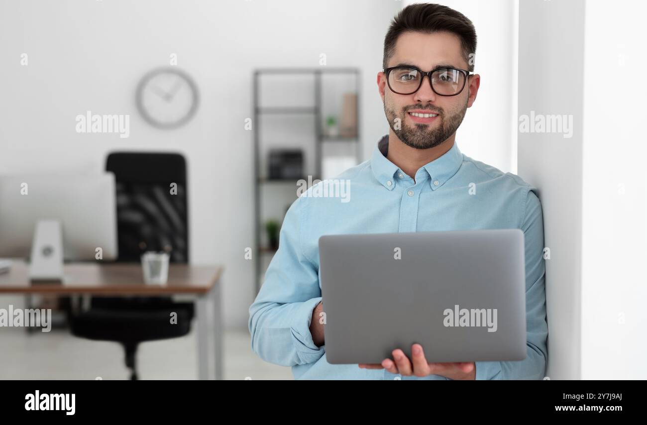 Programmer with laptop in office. Banner design Stock Photo
