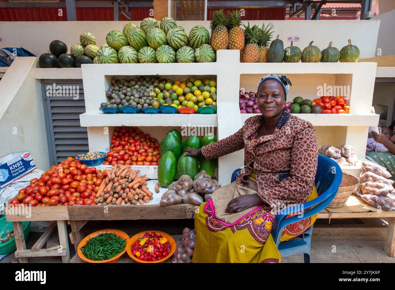 A woman selling fresh vegetables and fruits in Entebbe Market Uganda ...