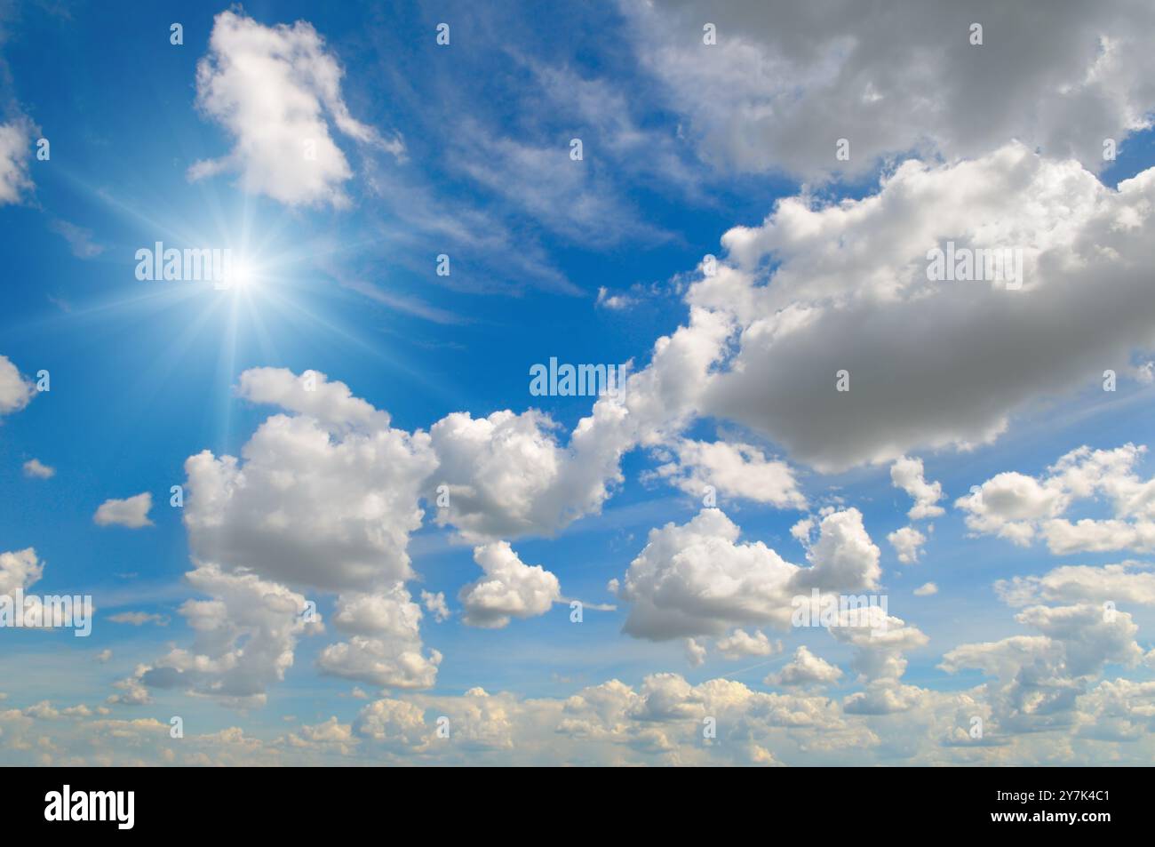 Blue sky with white clouds and bright sun Stock Photo - Alamy