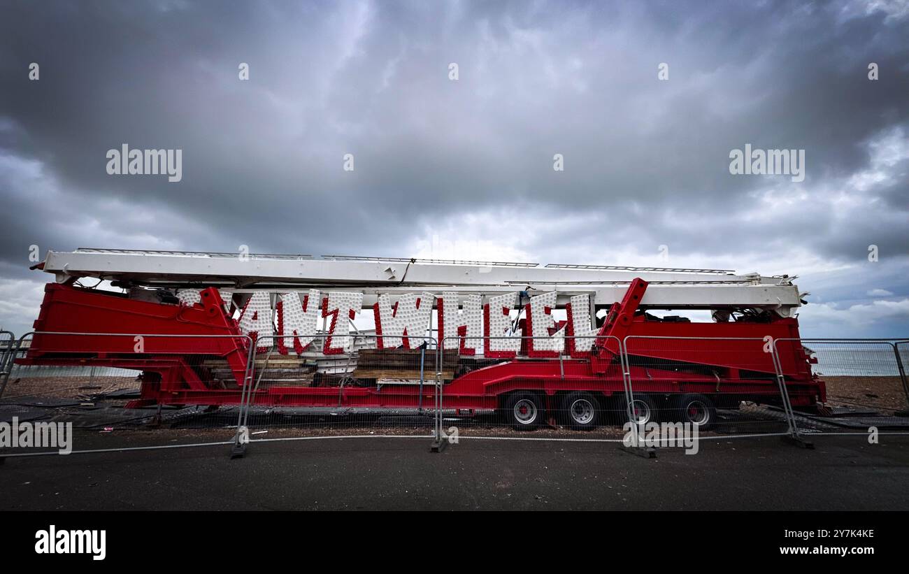 A Giant Wheel packed down on its transporter photographed on the promenade on Wednesday 25 September 2024 at Worthing Beach, Worthing. - Smartphone Captured Stock Image
