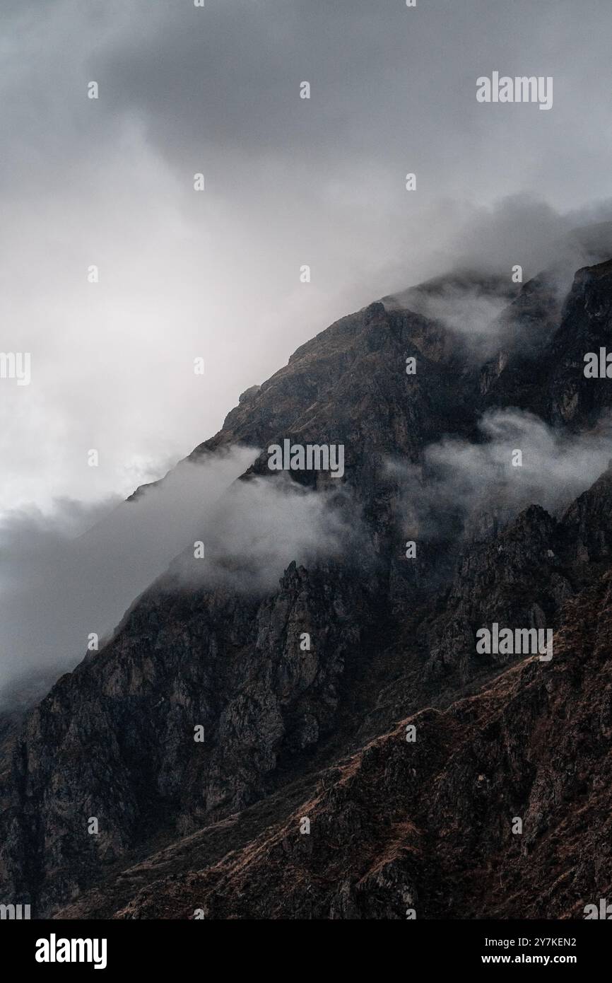 A dramatic mountain landscape shrouded in clouds and mist Stock Photo ...