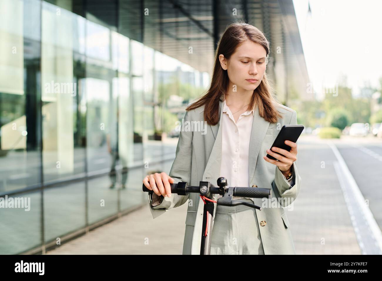 Young Woman Checking Map App On Smartphone Stock Photo
