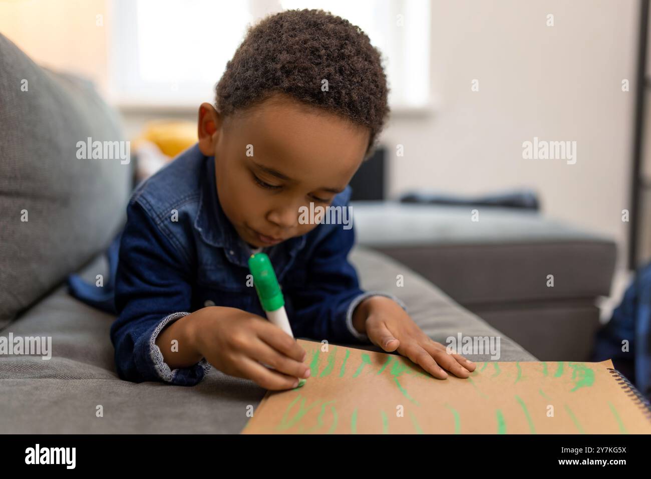 Kid Using Ink Joyful kid using marker to draw feeling the fun of art Stock Photo - Alamy