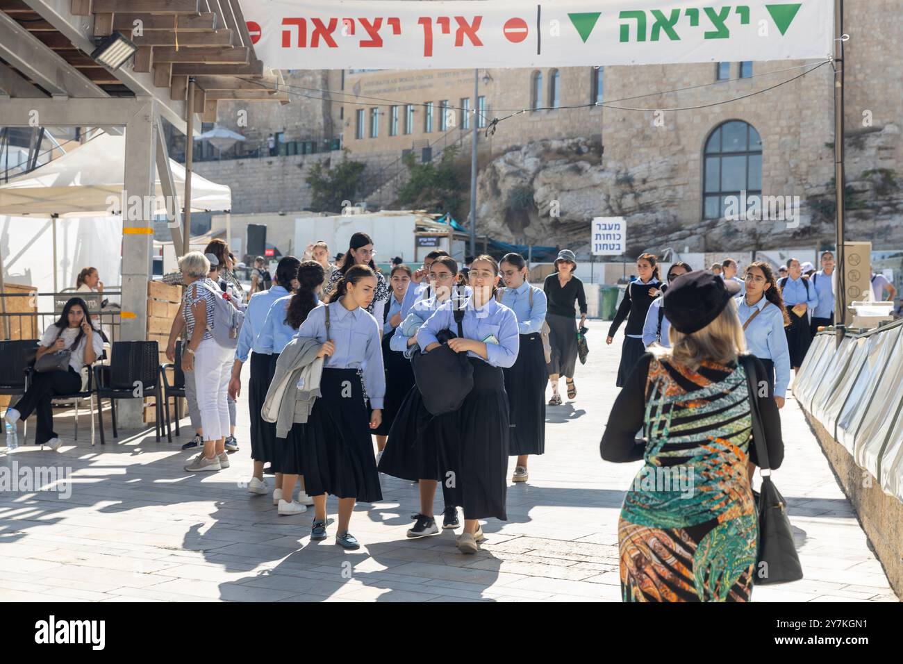 Jerusalem, Israel - September 30, 2024. Fourteen-year-old girls in school uniforms walk towards the Western Wall to offer prayers after their lessons. Stock Photo