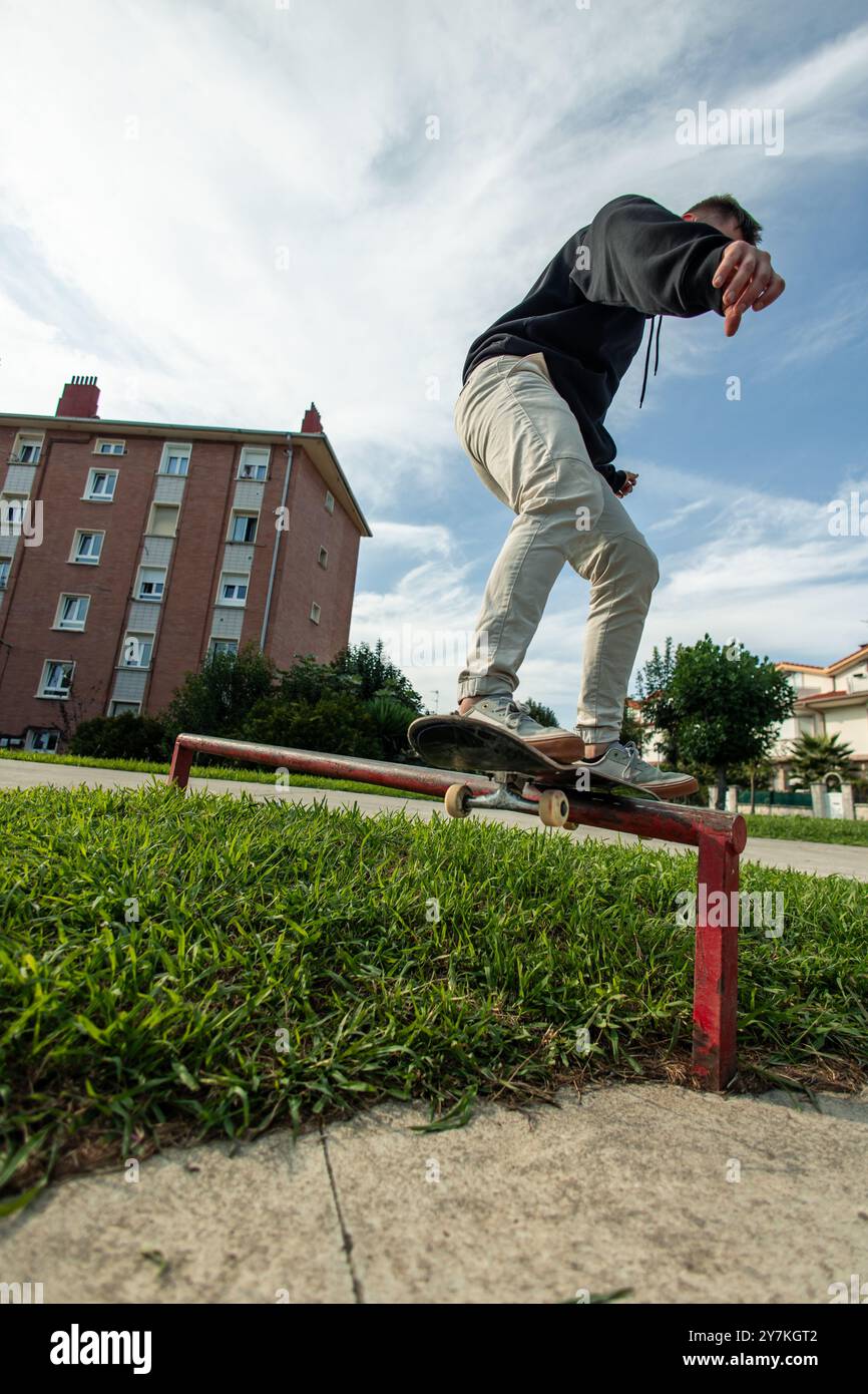 vertical unrecognized skater skillfully grinding a rail in the skate ...