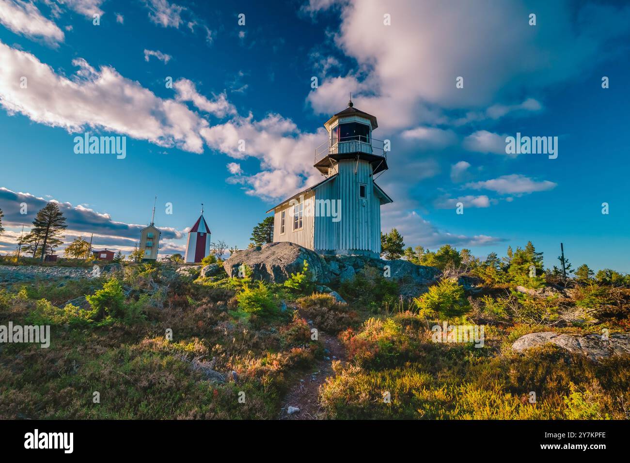 Lighthouse Rework September Historic Scandinavian lighthouse on rocky terrain under a bright sky ...