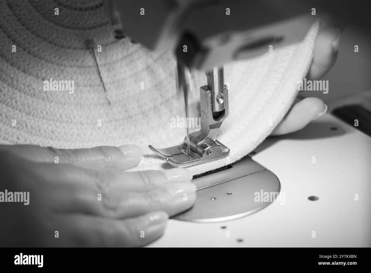Close-up of a woman's hands sewing on a sewing machine with moving ...