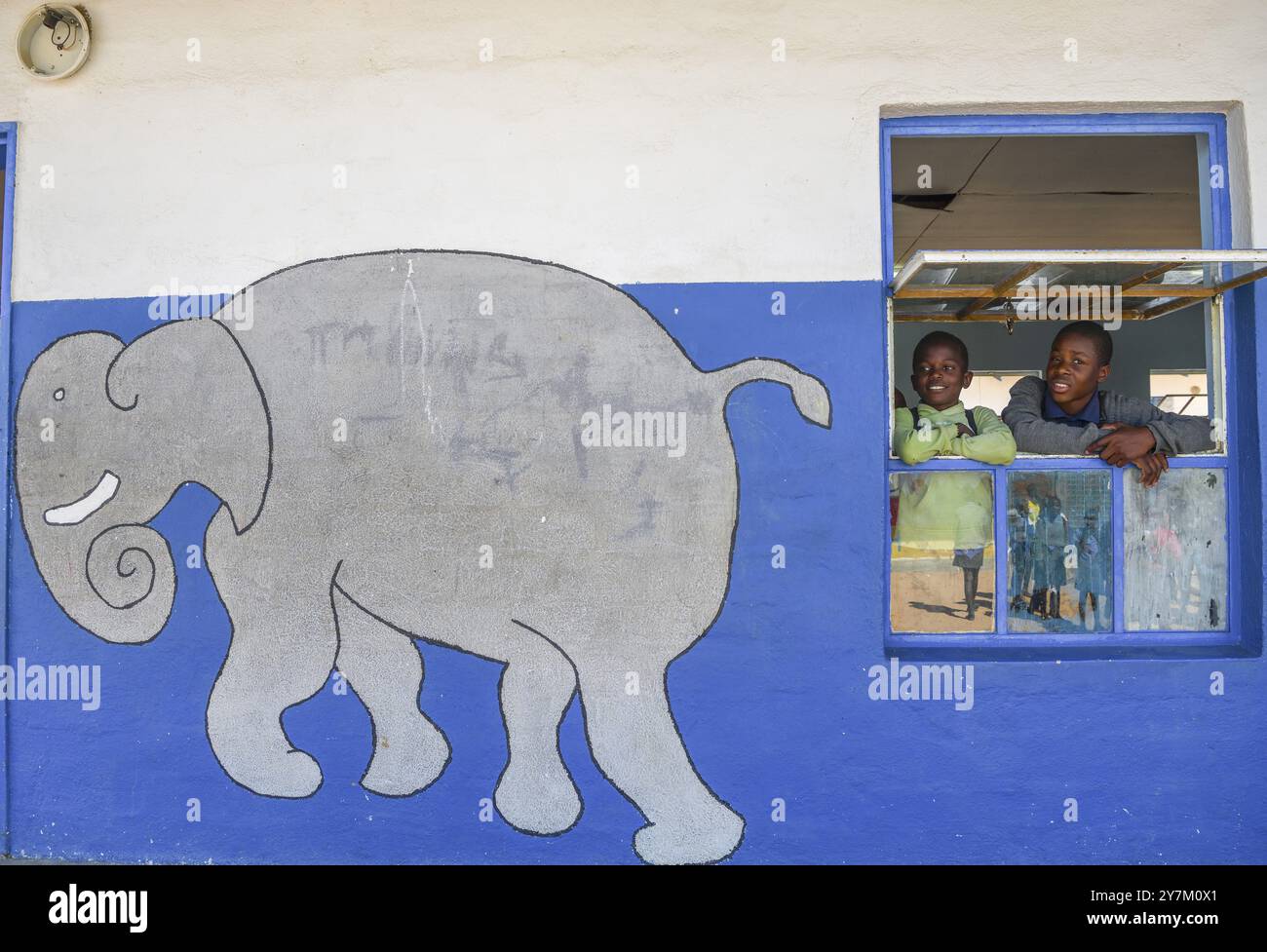 Children look out of the window of their classroom at Gariseb Primary School, boarding school for 350 children, Elephant, Anixab, Ugab Dry River, Dama Stock Photo