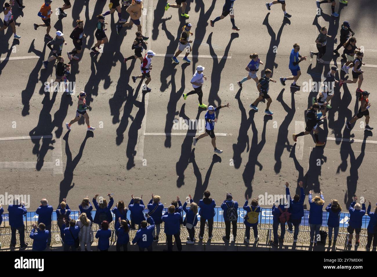 Marathon runners and their shadows at the 50th BMW Berlin Marathon 2024