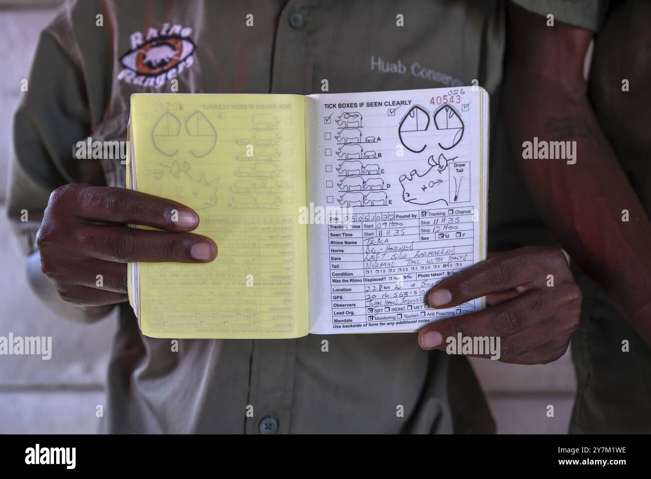 A ranger of the Rhino Rangers shows the data sheet of a rhino sighting ...