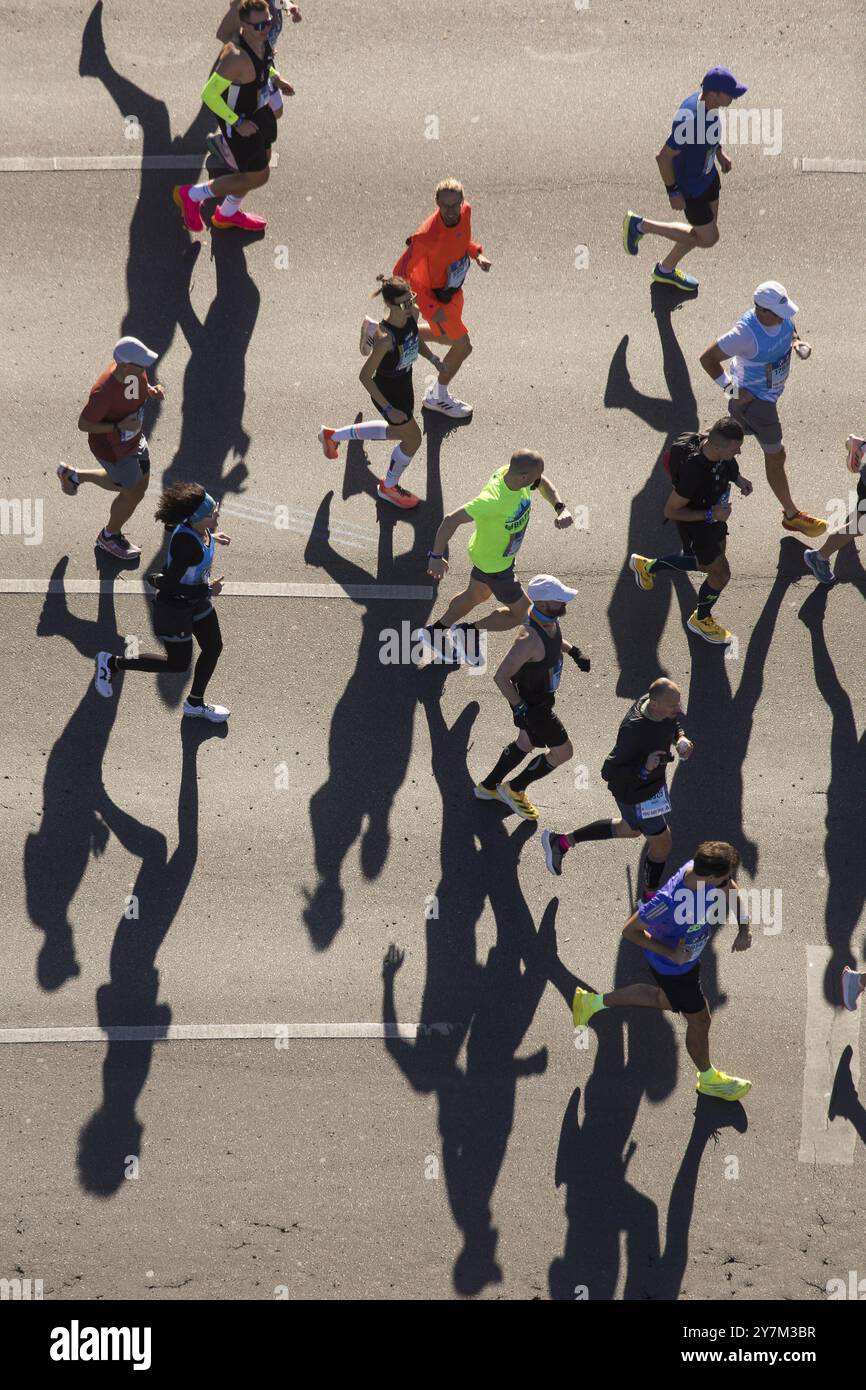 Marathon runners and their shadows at the 50th BMW Berlin Marathon 2024