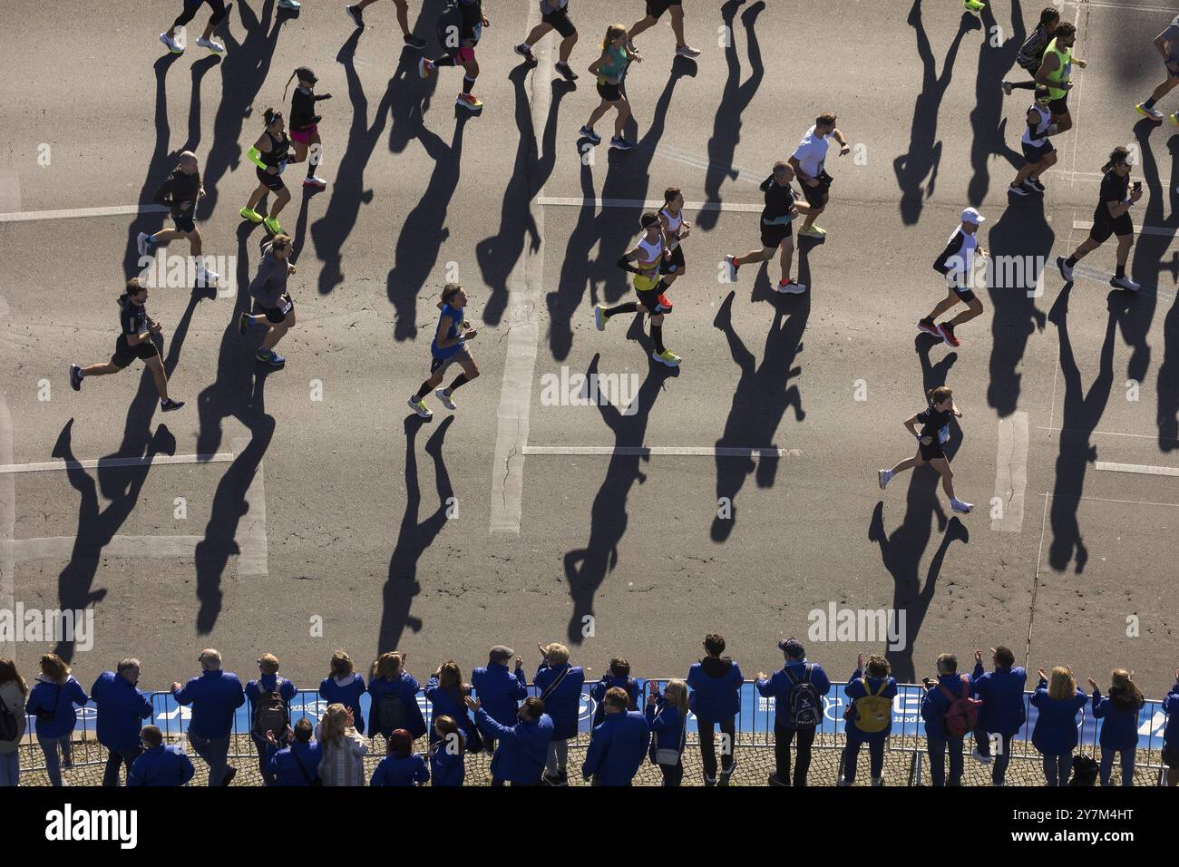Marathon runners and their shadows at the 50th BMW Berlin Marathon 2024