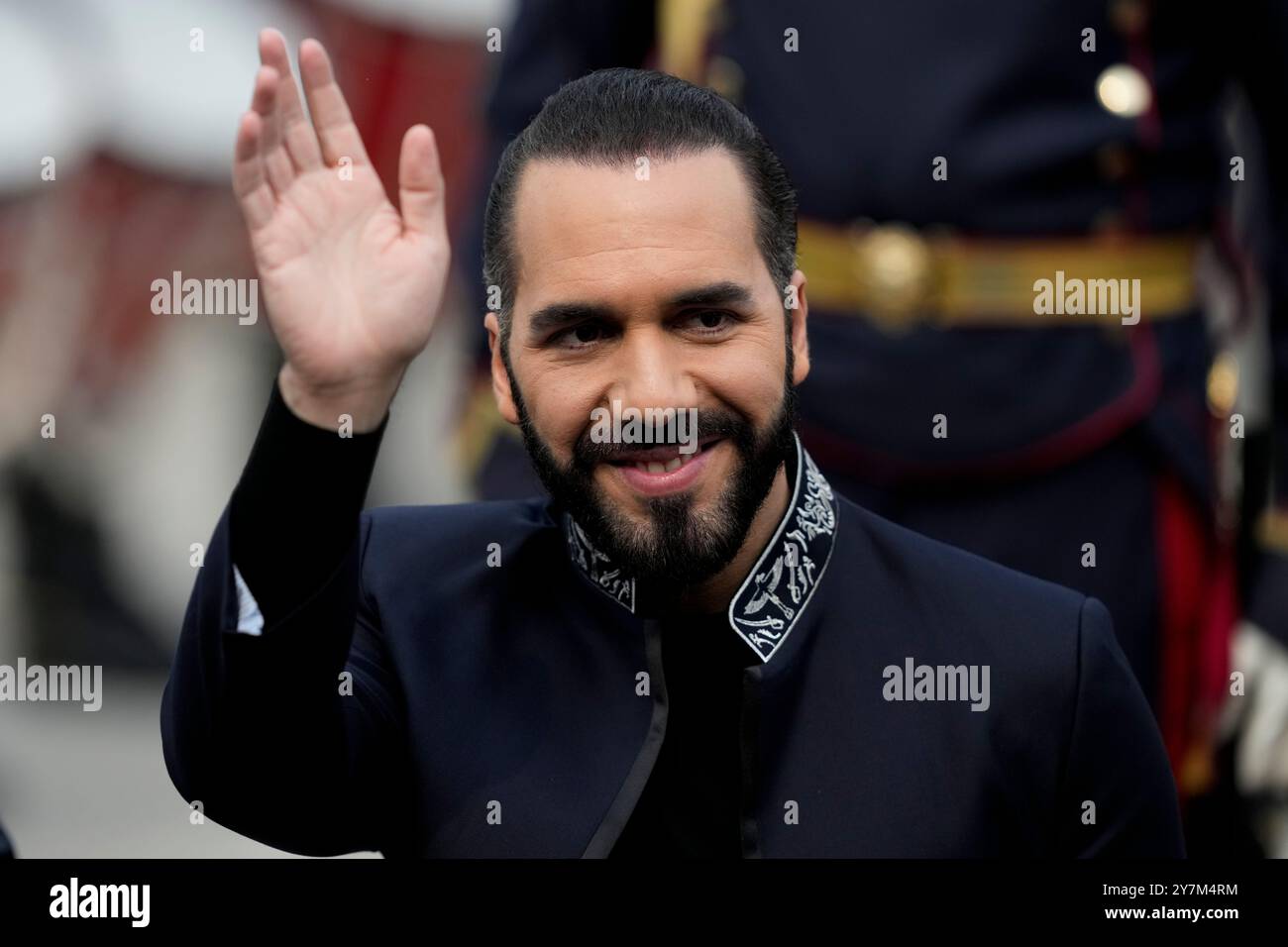El Salvador's President Nayib Bukele waves after a ceremony honoring
