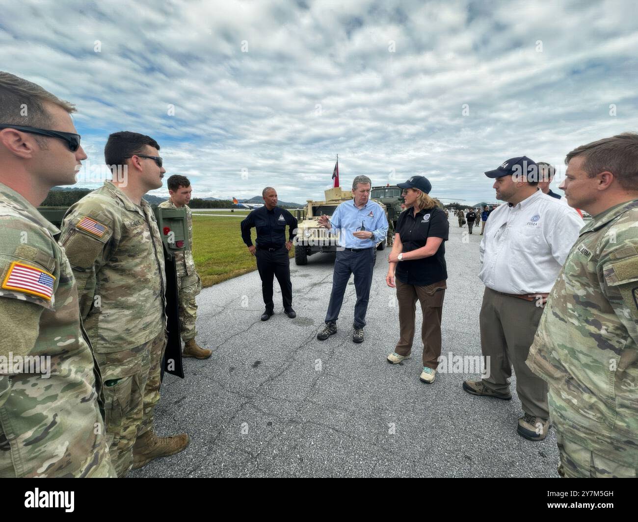 Asheville, United States. 30th Sep, 2024. North Carolina Governor Roy Cooper, center, FEMA Administrator Deanne Criswell, 3rd, and FEMA Region 4 Regional Administrator Robert Samaan, 2nd right, discuss relief efforts following extreme flooding caused by Hurricane Helene in the mountain towns, September 30, 2024 in Asheville, North Carolina. Credit: Madeleine Cook/FEMA/Alamy Live News Stock Photo