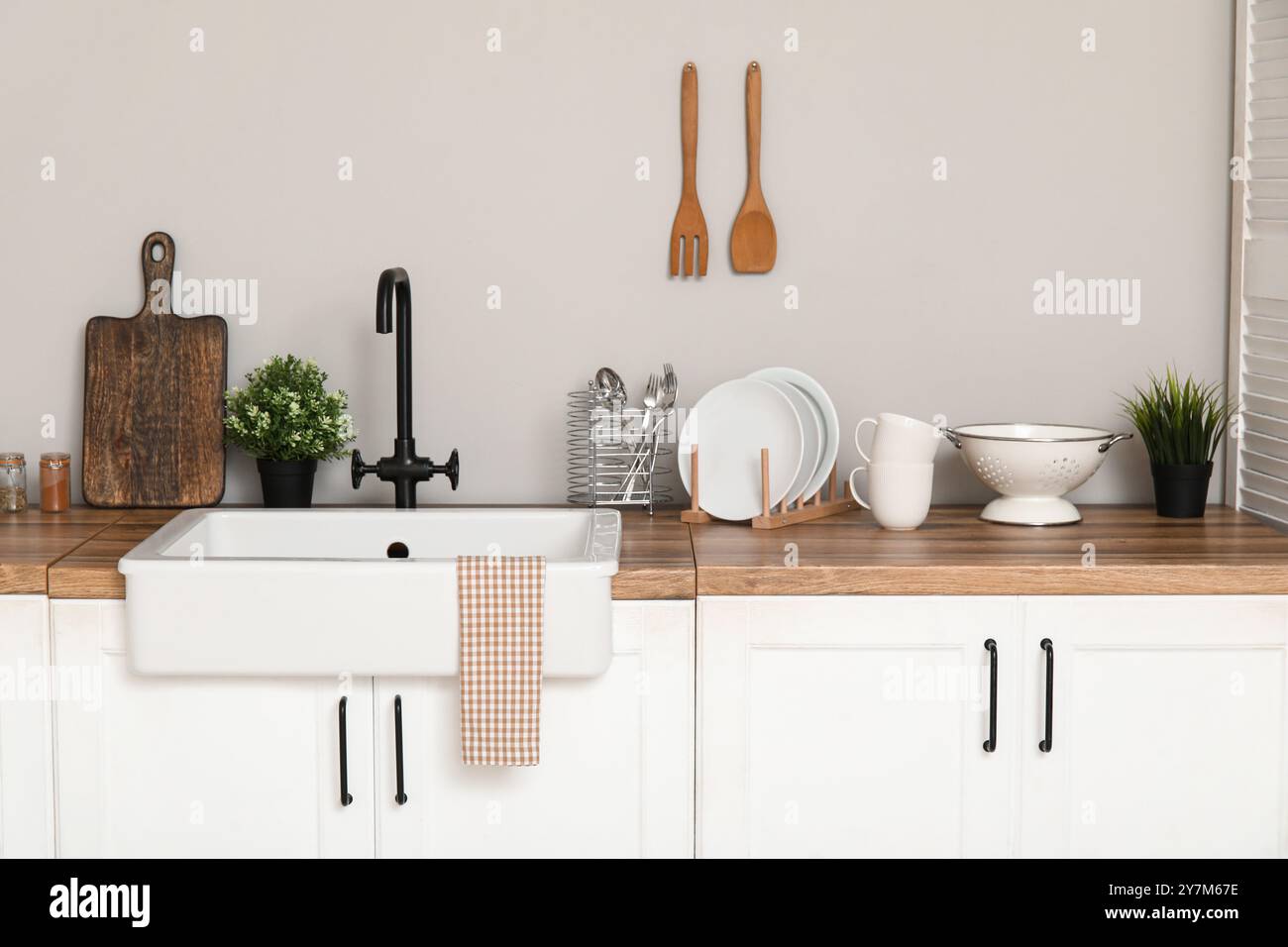 Interior of light kitchen with white counters, sink and utensils Stock ...