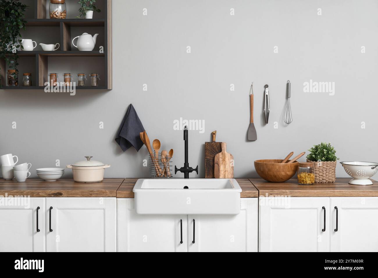 Interior of light kitchen with white counters, sink and utensils Stock ...