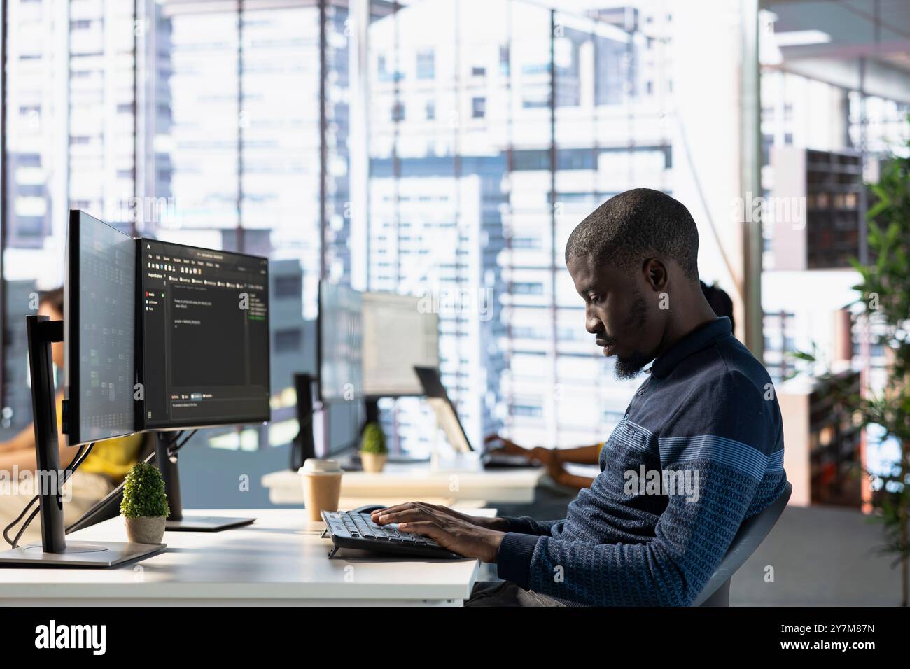 Computer technician doing software quality assurance, reading source code on computer before implementing it. IT admin inspecting coding on PC device, looking to fix potential issues Stock Photo