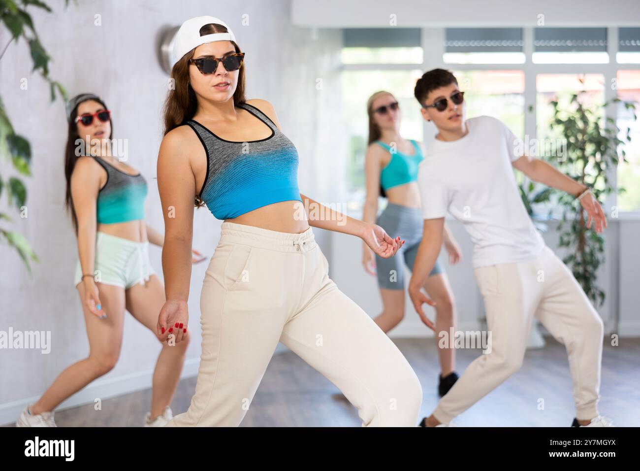 Young girl krumper dancing with group of teenagers in studio Stock Photo