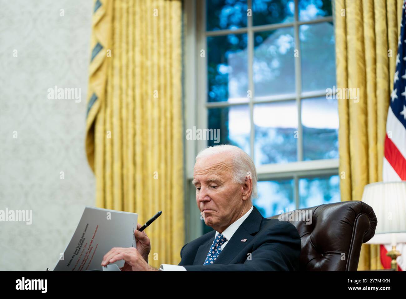 Washington DC, USA. 30th Sep, 2024. United States President Joe Biden speaks to the press pool after receiving a briefing from Governor Roy Cooper (Democrat of North Carolina) and Deanne Criswell, Administrator, Federal Emergency Management Agency (FEMA) on the latest operational updates from the impact of Hurricane Helene in the Oval Office at the White House in Washington, DC on Monday, September 30, 2024. Credit: Bonnie Cash/Pool via CNP /MediaPunch Credit: MediaPunch Inc/Alamy Live News Stock Photo