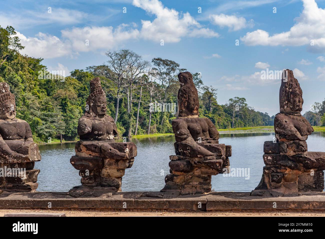 Statues along the bridge of the south gate to Angkor Thom, Cambodia ...