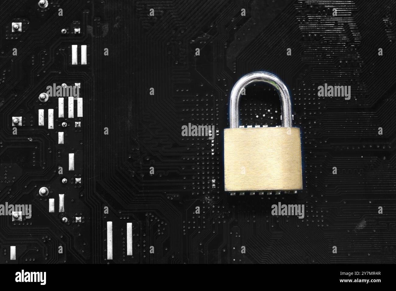 Golden master key in lock placed on a computer motherboard background ...