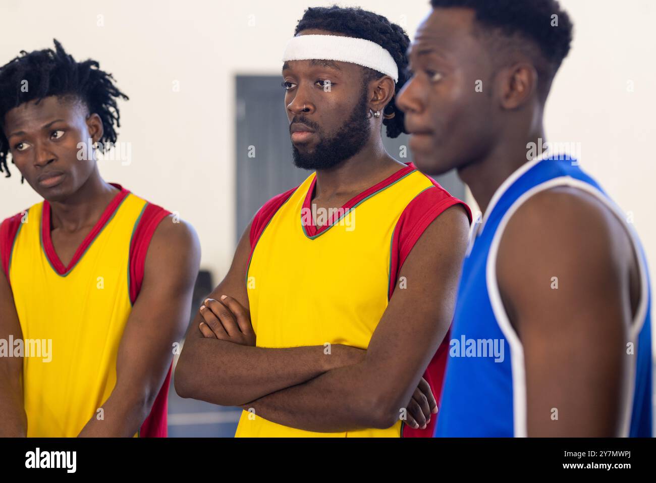 African American Basketball Players In Team Jerseys Standing Together african-american-basketball-players-in-team-jerseys-standing-together