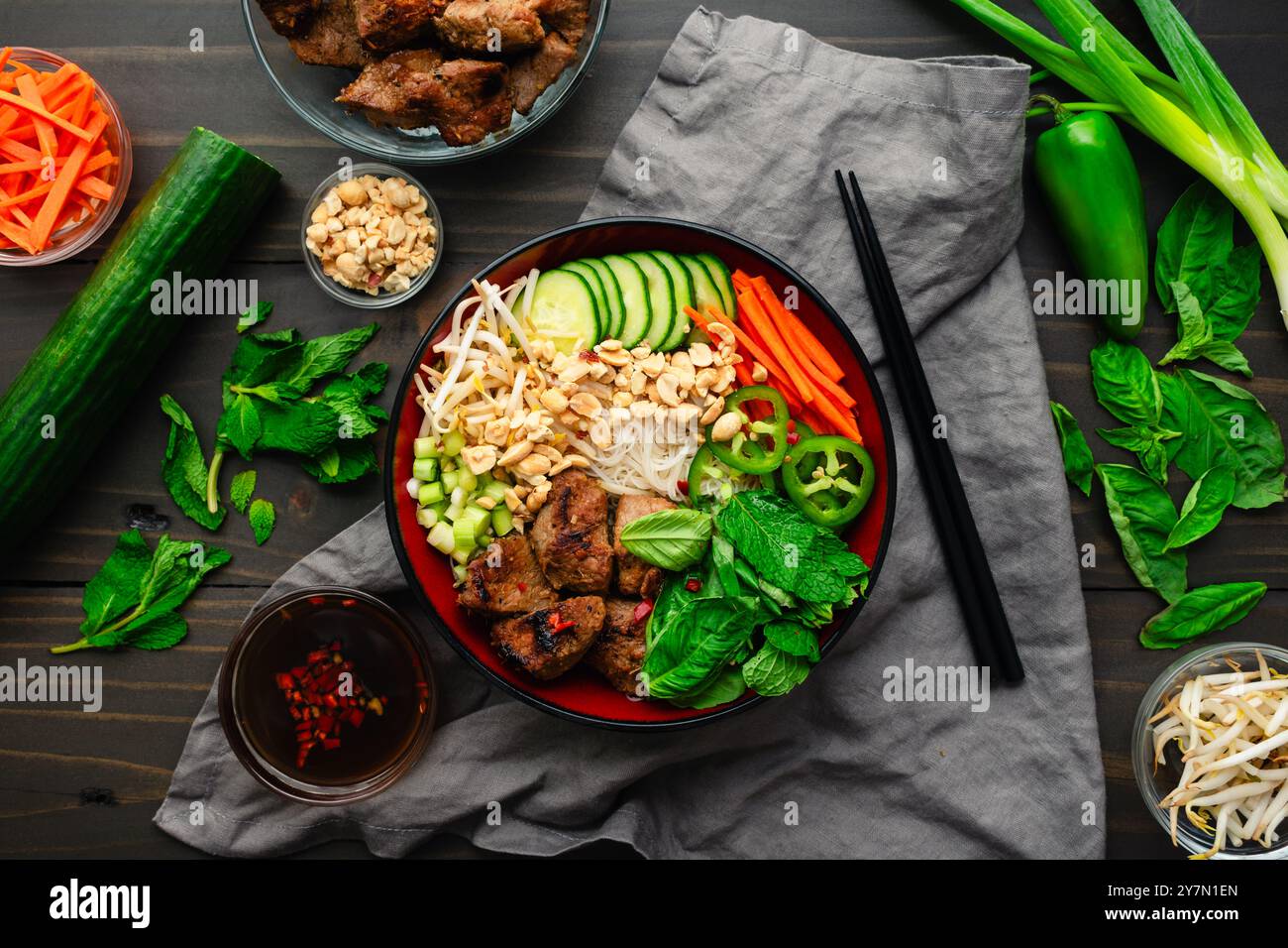 Bun Thit Nuong Vietnamese Grilled Pork with Nuoc Cham: Chunks of pork over vermicelli noodles with fresh herbs, peanuts, cucumber, and pickled carrots Stock Photo