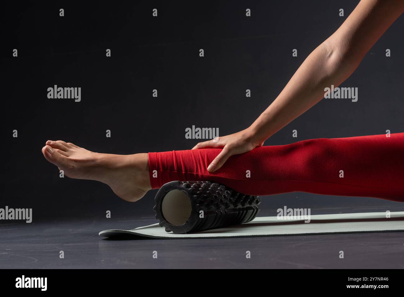 physiotherapy massage, woman with yoga roller on floor for leg tension ...