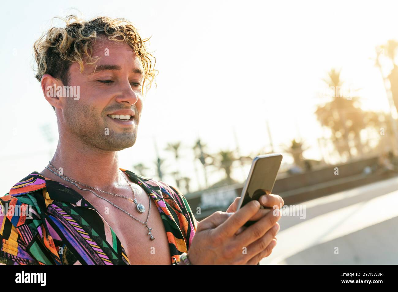 stylish millennial guy using mobile phone Stock Photo