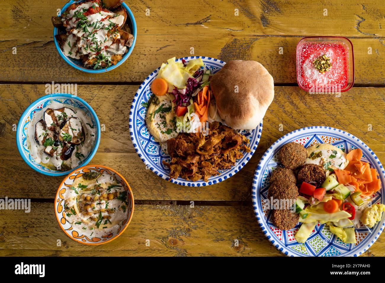 A selection of Iranian food dishes including marinated seitan shawarma, baba ganoush, houmous, falafel and panna cotta Stock Photo