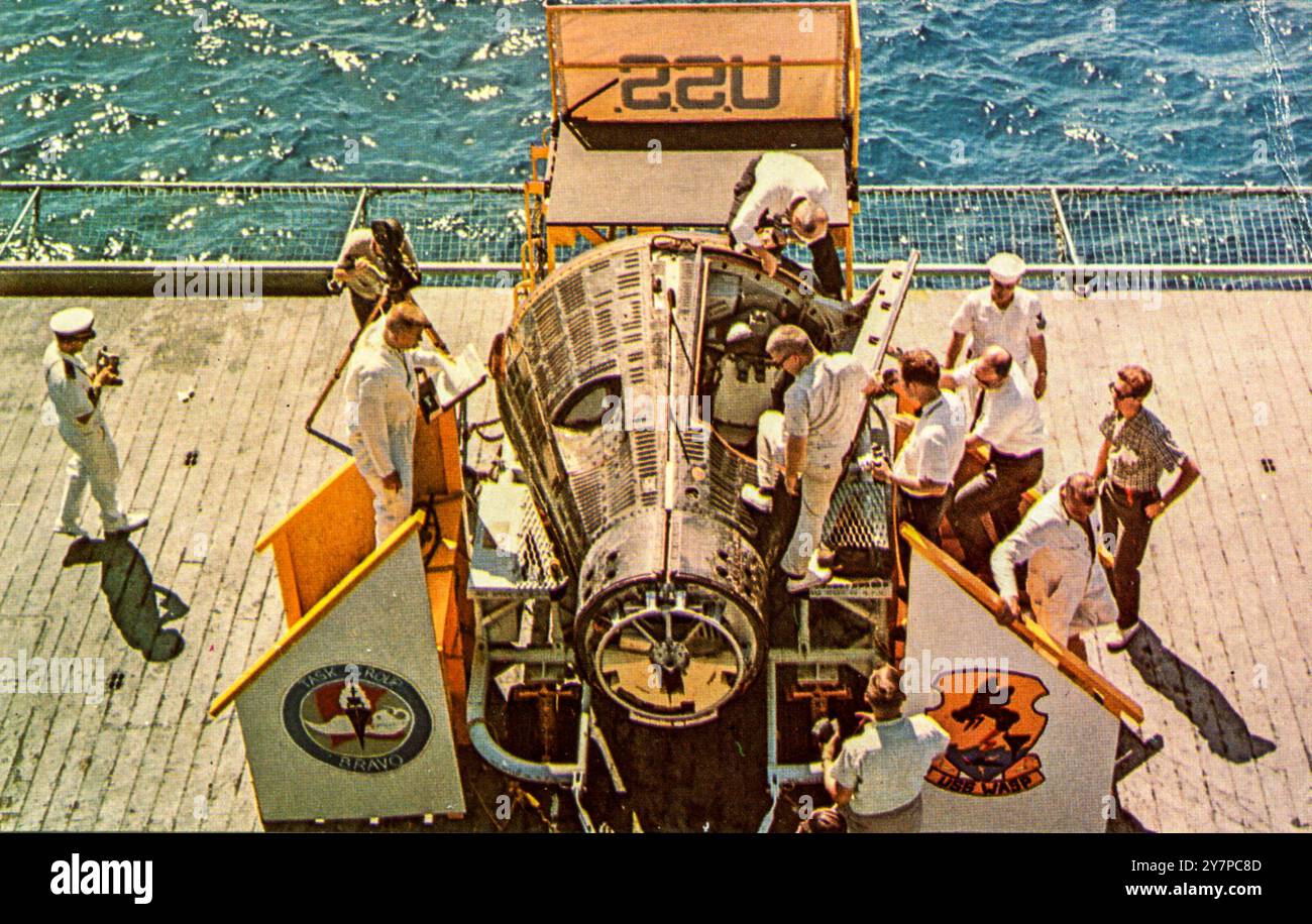 A vintage postcard image of the Gemini 4 NASA space module, the second crewed mission of the Gemini series, having returned to earth and been recovered onto the deck of the USS WASP IX in June of 1965 Stock Photo