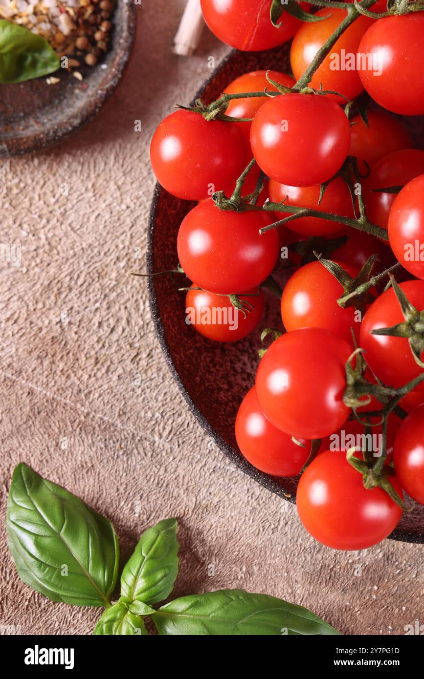 cherry tomatoes and basil on the table for healthy eating Stock Photo ...
