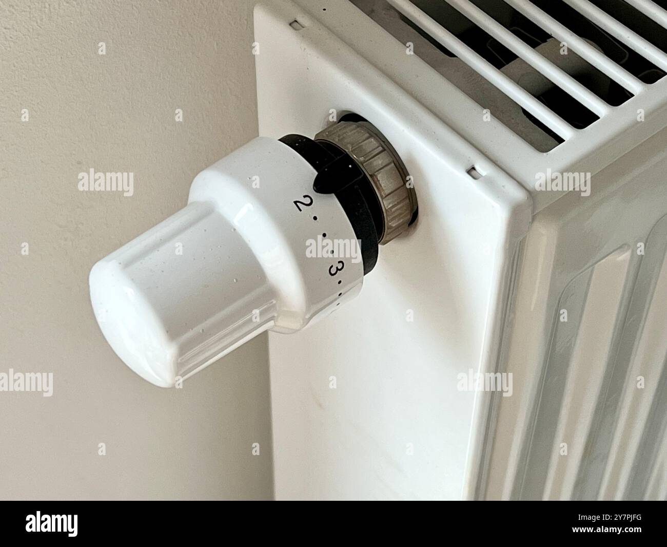 Close-up of the radiator. Close-up of the temperature control on the radiator. The beginning of the heating season, a cold snap. Heating of the room. - Smartphone Captured Stock Image