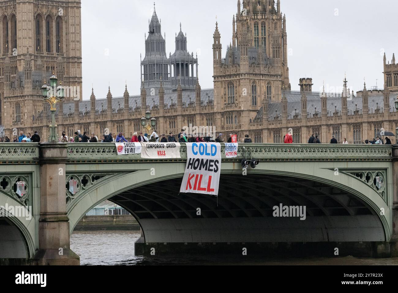 London, UK. 1 October, 2024. Fuel poverty campaigners perform a banner drop on Westminster Bridge timed to coincide with an increase in energy prices approved by OFGEM (Office of Gas and Electricity Markets), the government regulator for electricity and gas markets. Typical energy prices are rising by 10% today and follow the controversial scrapping of the Winter Fuel Allowance affecting millions of pensioners. The action was part of series of nationwide protests calling for public ownership of energy generation and affordable fuel. Credit: Ron Fassbender/Alamy Live News Stock Photo