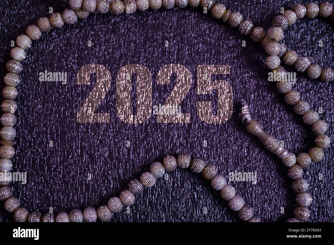 2025 Islamic concept background with prayer beads on purple background Stock Photo