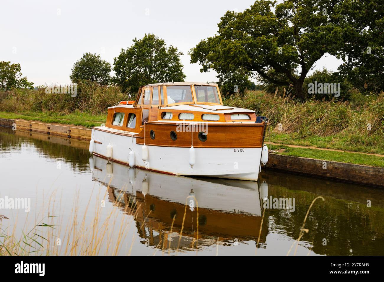 Wooden, traditional Norfolk broads cruiser boat moored. Horsey, Norfolk, England Stock Photo