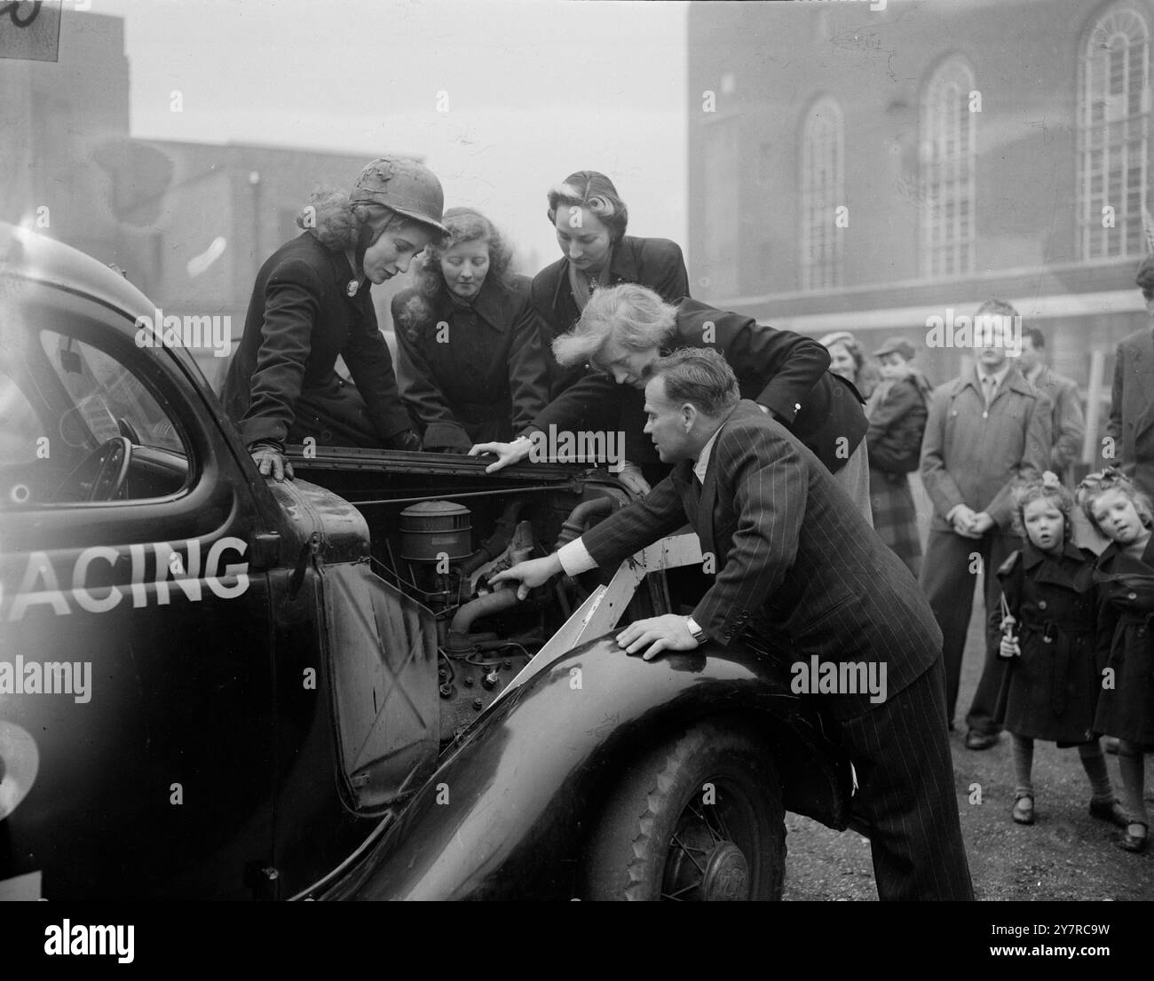 STOCK-CAR RACING DRIVERS MEET 14.2.54. Despite the opposition of the Royal Automobile Club - the governing body of motorsport in this country - bumper car racing is coming to London. Drivers with their cars met today at the New Hammersmith Town Hall to discuss a program that will take place at New Cross Stadium on Good Friday. Bumper car racing consists of about six cars on a narrow track which meet in a 'boomps-daisy' act on the bends. A million-pound sports promotion concern is backing the venture. Its directors include several names famous in sport, some of whom are also officials of the R. Stock Photo