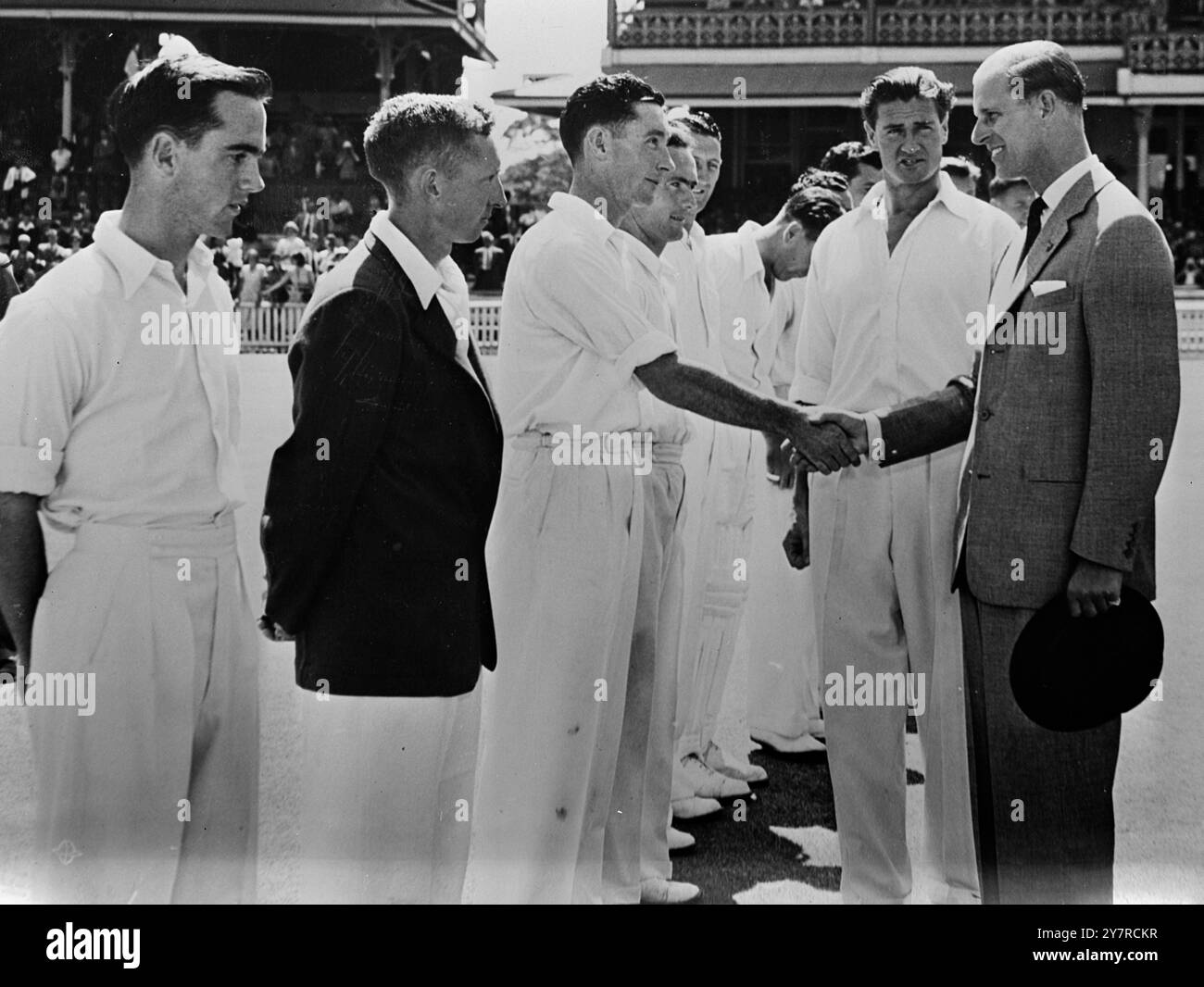 QUEEN'S ROYAL VISIT TO AUSTRALIA 10.2.54. I.N.P. photo shows H.R.H. the Duke of Edinburgh making his surprise visit to the N.S.W. vs. Western Australia cricket match at the Sydney Cricket Ground on February 6. Keith Miller, the N.S.W. captain, introduces the N.S.W. team to the Duke. 59/MB/ 74466 International News Photo. Stock Photo