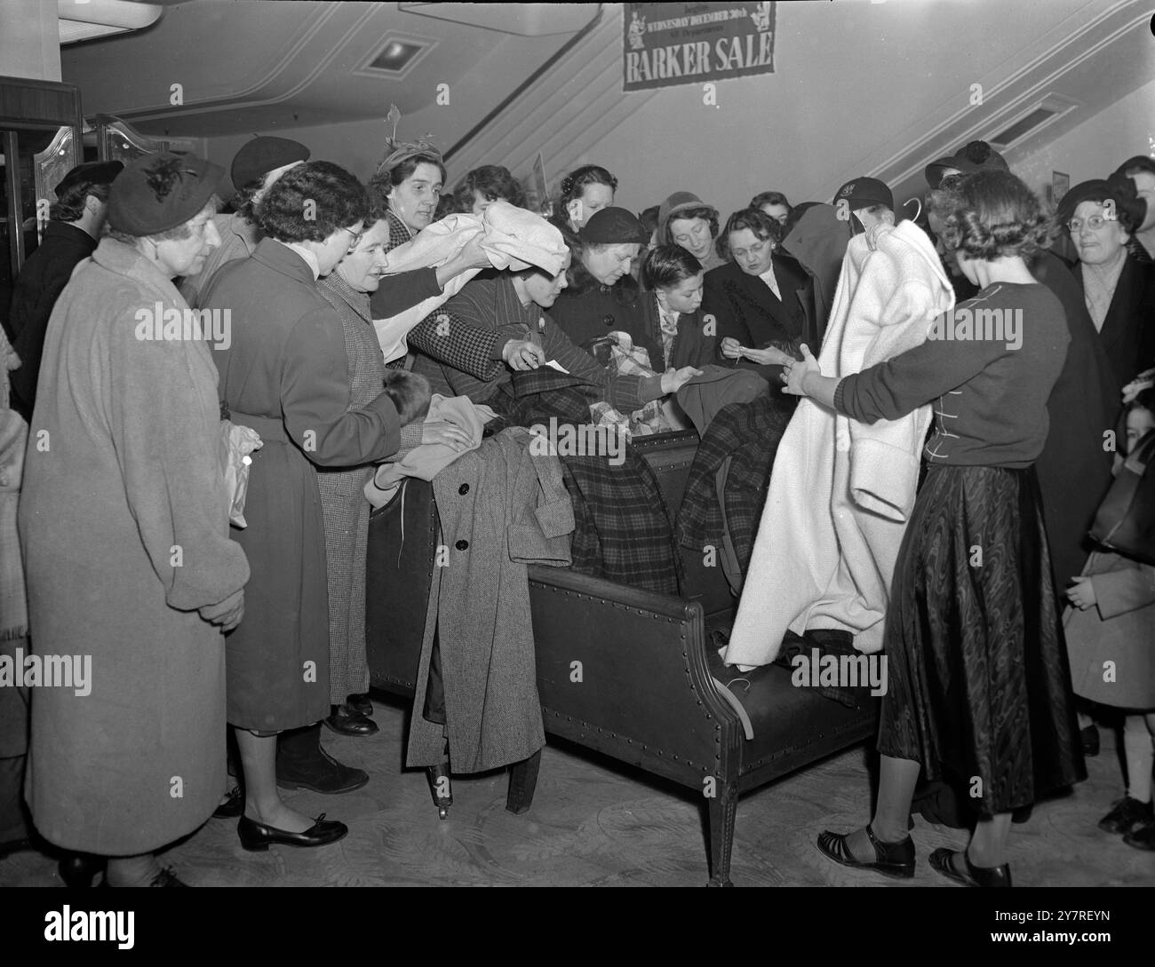 The winter sales are here. 30.12.53. In stores all over the country, the Christmas decorations have been torn down and replaced by sale tickets. The bustle of gift-buying has given way to the frenzy of bargain-hunting. INP photo shows shoppers at John Barker & Co., Ltd., Kensington High Street, London, this morning. Picture by Jack Davies. PJ/73512. International News Photos. Stock Photo