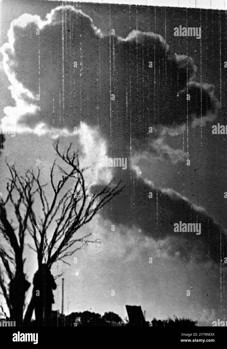 PICTURE BY RADIO BRITAIN'S ATOMIC EXPLOSION 15.10.53. The news that Britain's atomic weapon had been successfully exploded on the proving ground northwest of Woomera in the Australian desert was signalled to Sir Winston Churchill yesterday evening by Sir William Penney, the scientist in charge of the test. Unofficial reports say that the 'Weapon' was in fact Britain's first operational atom bomb, small enough to be dropped from an aircraft. The test explosion was made from a steel tower which was completely vaporised. I.N.P. PHOTO SHOWS: Scene taken shortly after the atomic explosion this morn Stock Photo