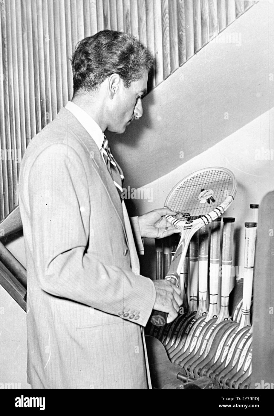 HAPPY SHAH PREPARES FOR RETURN - 20.8.53. - . - The Shah of Persia who fled to Rome earlier this week today - received a telegram from Teheran inviting him to return - 14 - there immediately following the overthrow of Dr. Mossadeq's - government. - I.N.P. photo shows The Shah buying s tennis racket during - a shopping expedition in Rome. - 3/PJ/70671 - International News Photos Stock Photo