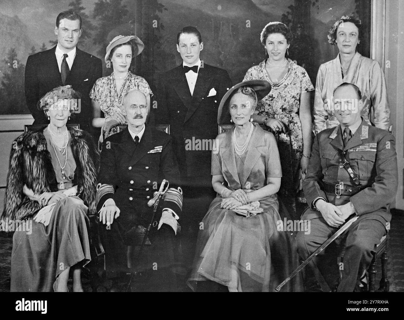 PRINCE HARALD OF NORWAY CONFIRMED H.R.H. Prince Harald of Norway, who is 16, was last Sunday confirmed by Bishop Eivind Berggrav in the Royal Chapel.  Photo shows : A group posed to commemorate the Confirmation after the ceremony. Left to right, seated: H.R.H. Princess Ingeborg; H.M. King Haakon; H.R.H. Crown Princess Martha; H.R.H. Crown Prince Olav. Standing, left to right: Ship-owner Mr. Erling Lorentzen, the fiancee of Princess Ragnhild; H.R.H, Princess Ragnhild; H.R.H. Prince Harald; H.R.H. Princess Astrid; H.R.H. Princess Margaretha. 12 May 1953 Stock Photo