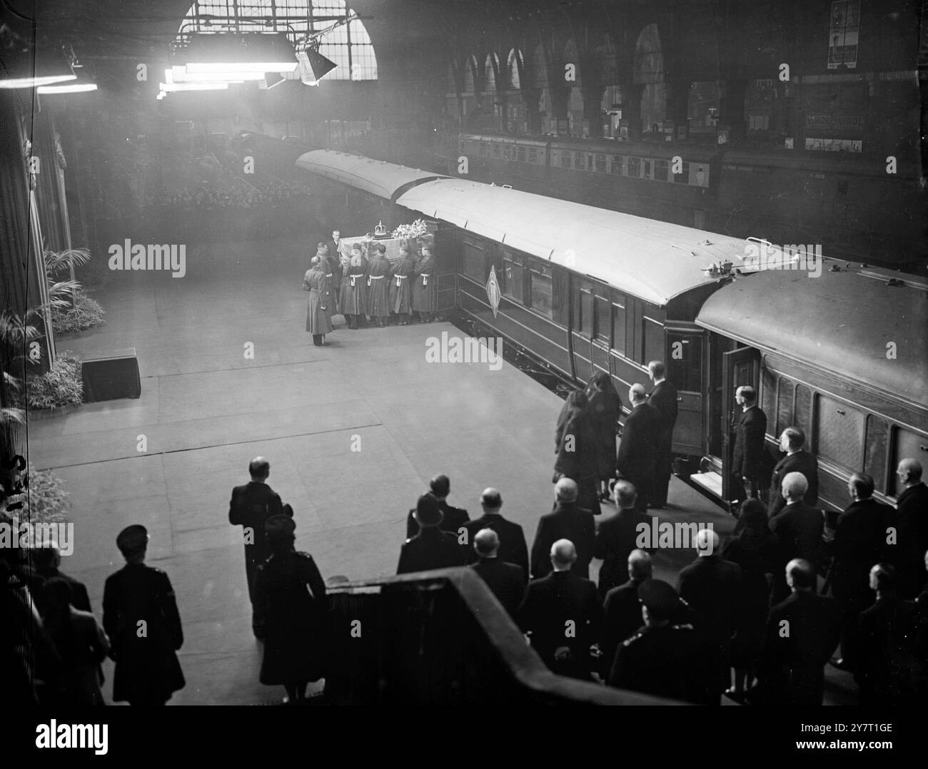 KING'S COFFIN ARRIVES IN LONDON          11-2-52          The scene at London's King's Cross Station this afternoon when the King's coffin arrived by train from Wolferton after the Sandringham procession. On the coffin rests the Imperial State Crown, worn by all reigning monarchs on all state occasions other than the coronation, and the Orb and Sceptre. The orb symbolises the world dominated by Christianity. The Sceptre, with the Cross of St. George set on it in rubies, is the 'Ensign of Kingly Power and Justice'. Also on the coffin is the wreath from the Queen Mother  11 February 1952 Stock Photo