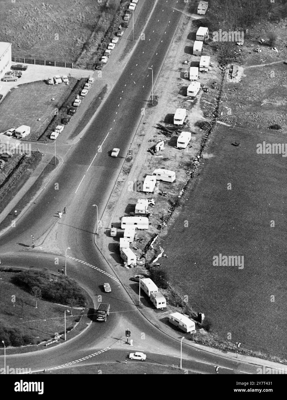 Air view of some of Kent's trunk road dwellers - The A20 London - Folkestone road near Crittall's Corner on the Sidcup bypass , where a small colony of Roma have chosen to set up camp on the grass verges. The owners appear to be in the scrap metal business as they gather broken down cars and various piles of metal. 26 March 1967 Stock Photo